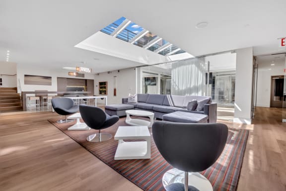 a living room with couches and chairs and a rug