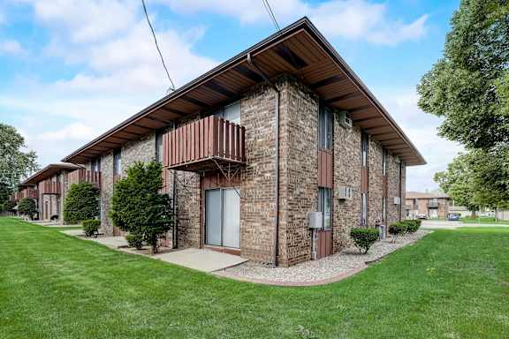 A modern multi-story building with a mix of brick and white exterior walls.