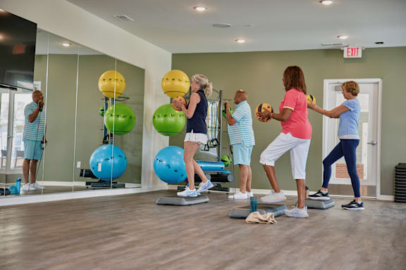 A group of people exercising in a gym.