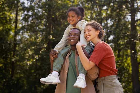 a man and woman with a child on their shoulders