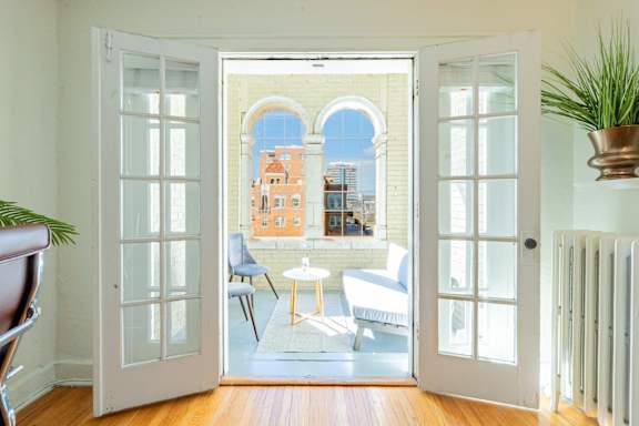 A view of a balcony through an open door.