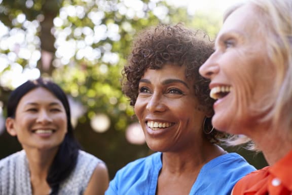 a group of women laughing and smiling together at Osprey Park 62+ Apartments, Kissimmee