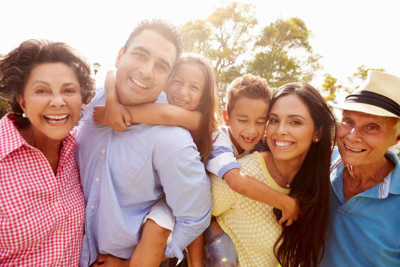 a family is posing for a picture while smiling at the camera