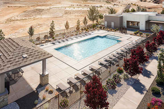 A pool surrounded by trees and a building in the background.