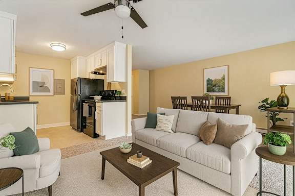 A living room with a white couch and a coffee table.