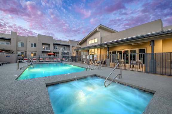 A swimming pool in a sunny outdoor setting.