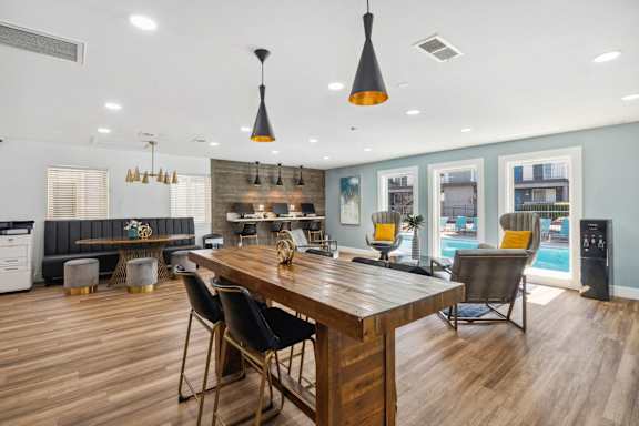 a large dining room with a wooden table and chairs