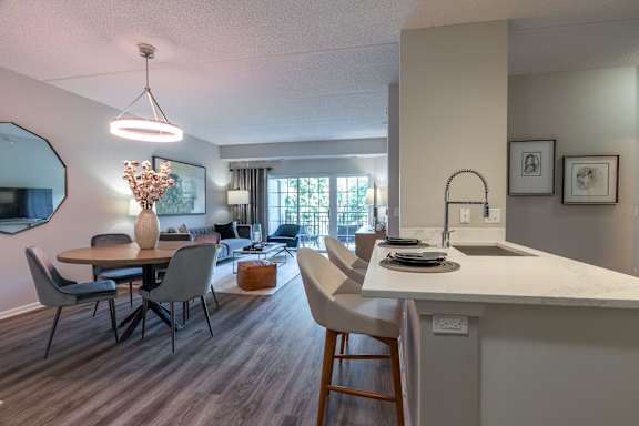 A modern kitchen with a dining table and chairs.