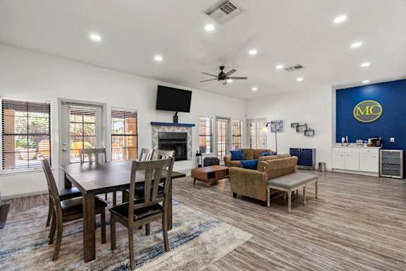A living room with a dining table and chairs.