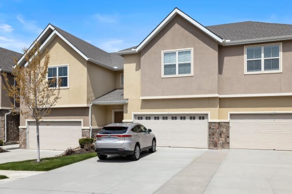 a car parked in a driveway in front of a house