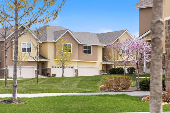 a house with a lawn and trees in front of it