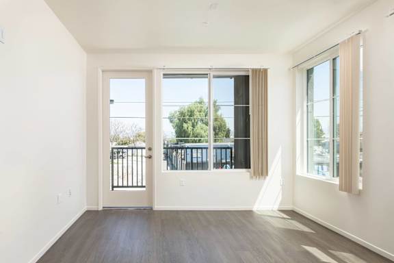 A room with a white wall and a wooden floor.
