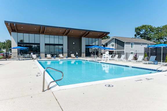 A large swimming pool with club house at Addison Princeton Apartments