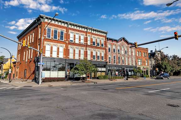 a large brick building on the corner of a city street