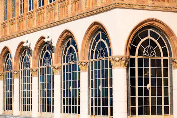 A row of arched windows with ornate frames.
