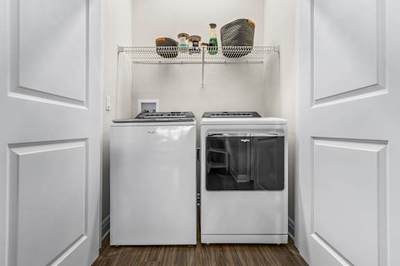 A white kitchen with a dishwasher and a refrigerator.