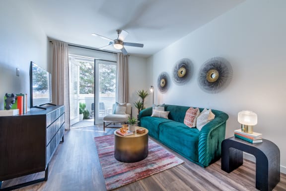 a living room with a green couch and a tv