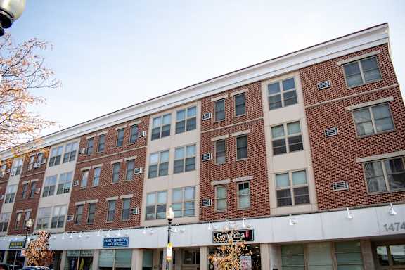 a large brick building with a sign in front of it