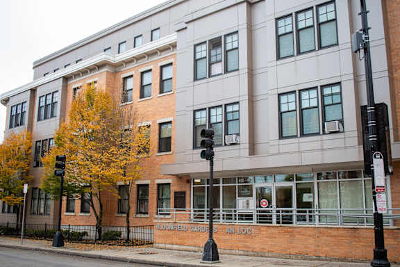 a building on the corner of a street with a traffic light
