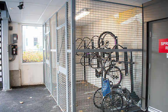 the bike rack in the entrance of a building with bikes in it