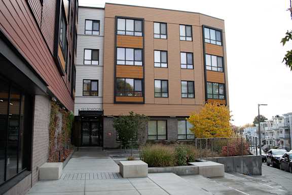 the exterior of a building with a sidewalk in front of it