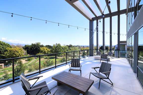 Park on First Apartments Outdoor Balcony with String Lights and Patio Furniture