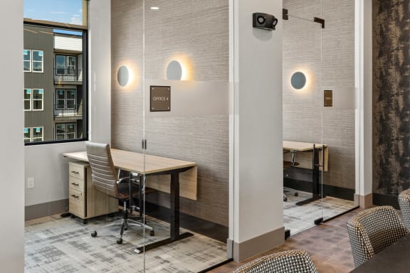 a conference room with a table and chairs and a window