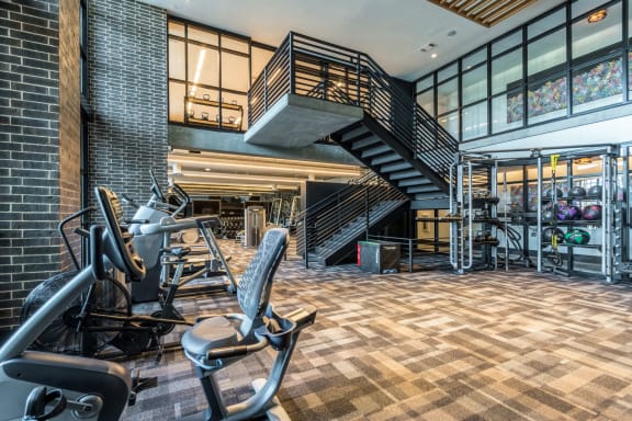 gym with stairs and workout machines at The Case Building in Dallas, TX