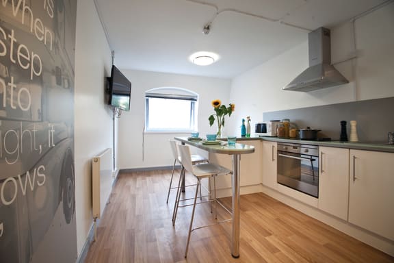 a kitchen and dining area with a table and chairs