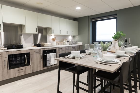 an open kitchen and dining area with a table and chairs