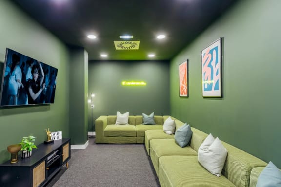 a living room with green walls and yellow couches
