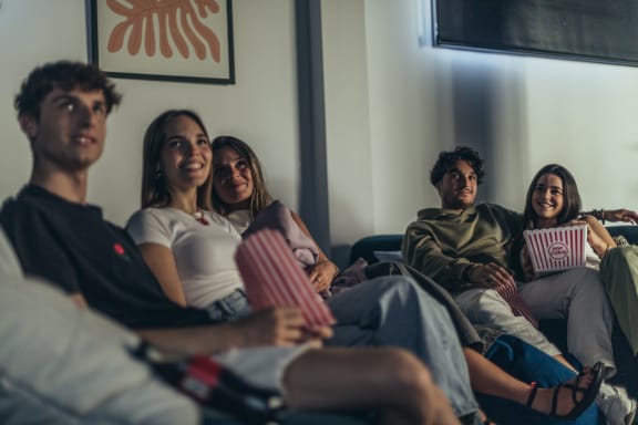 a group of people sitting on a couch laughing