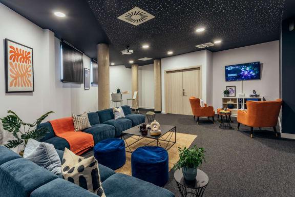 a living room with couches and chairs and a television
