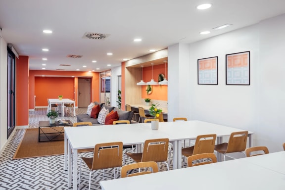 a dining room and living room with white tables and chairs