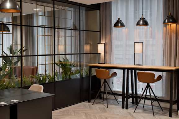 a dining room with a table and chairs and a large window