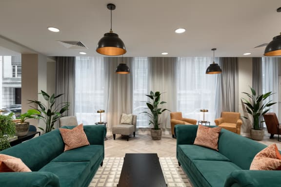 communal lounge with green couches and chairs