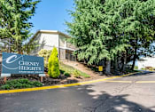 Thumbnail 8 of 8 - A sign for Cheney Heights Apartment Homes is in front of a building.