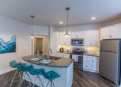 Thumbnail 5 of 11 - Spacious white kitchen at Quarry Apartments and Townhomes in DeWitt, Michigan