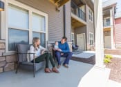 Thumbnail 9 of 11 - Residents on patio at Quarry Apartments and Townhomes in DeWitt, Michigan