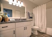 Thumbnail 10 of 23 - Bathrooms are modern and updated in the deluxe floorplan apartment home.
