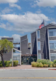 people sitting on benches in front of a tall building