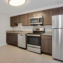 a kitchen with wooden cabinets and stainless steel appliances