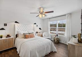 a bedroom with a bed and a ceiling fan at The Summit Townhomes in Oak Ridge, 37830