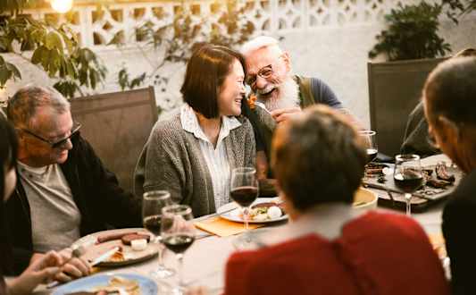 A group of people are enjoying a meal together at a restaurant.