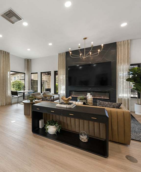 A modern living room with a fireplace and a TV.