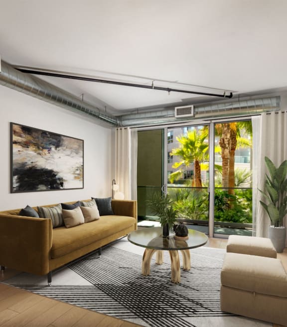 a living room with a couch and a coffee table and a large window  at The LC, Los Angeles, California