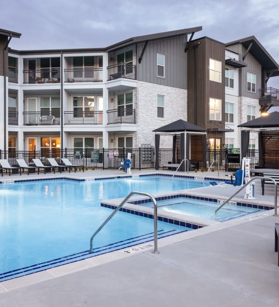 a swimming pool in front of an apartment building