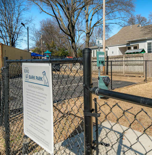 A sign on a fence that says "BIRK PARK".