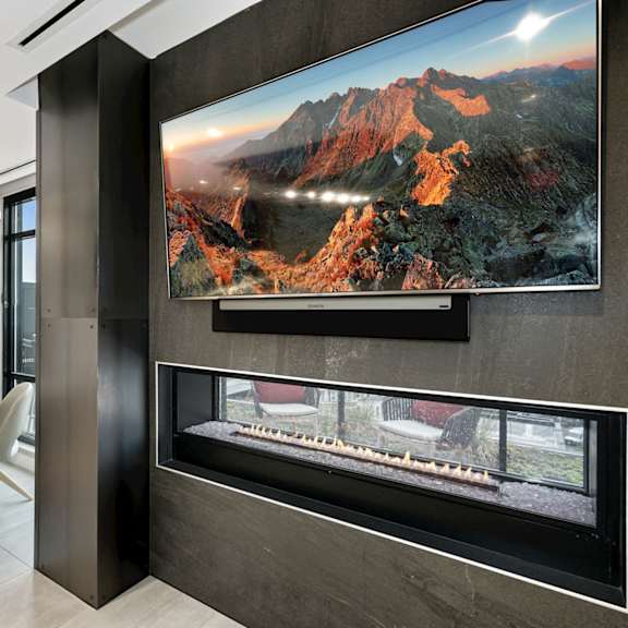 a dining room with a fireplace and a table and chairs