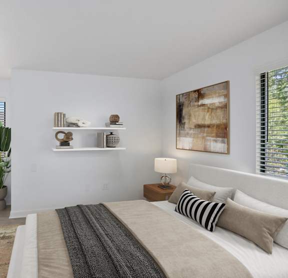 A bedroom with a bed, a rug, a potted plant, and a painting on the wall.
